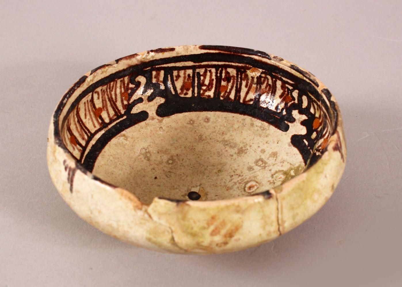 AN EARLY PERSIAN NISHAPUR POTTERY BOWL, possibly 10th Century, 12cm diameter.
