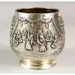 A SMALL EASTERN SILVER PEDESTAL BOWL, embossed decoration depicting figures and trees, 8cm high.
