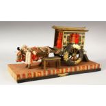 A JAPANESE GILT LACQUER CART AND OX DOLL ON STAND, overall 31.5cm long.
