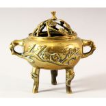 AN EARLY 20TH CENTURY CHINESE POLISHED BRONZE TWIN HANDLE CENSER AND COVER, supported on tripod