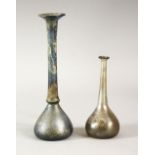 TWO EARLY SLENDER GLASS VESSELS, possibly roman, 10cm and 16cm high.