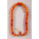 A GOOD SET OF CHINESE OR ISLAMIC AMBER PRAYER BEADS, the string comprising of 36 beads and toggle