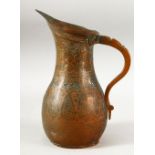 A 19TH CENTURY PERSIAN QAJAR COPPER JUG, 24.5cm high.