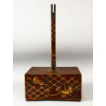 A JAPANESE WOOD AND LACQUER STAND, the base decorated with cranes and gilt latticework, the front