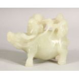 A CARVED WHITE JADE FIGURE riding a buffalo, 9cm long.