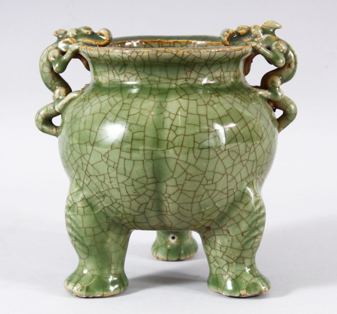 A GOOD CHINESE CRACKLE GLAZE CELADON TRIPOD CENSER, the handles formed as dragons, 15.5cm high.