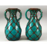 A PAIR OF JAPANESE TURQUOISE GROUND TWIN HANDLE BAMBOO ENCASED VASES, each approx. 24.5cm high.