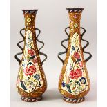 A PAIR OF IZNIK STYLE TAPERING VASES, with wavy handles, 36cm high.