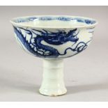 A CHINESE BLUE AND WHITE PORCELAIN STEM CUP, decorated with a dragon, 13cm diameter.