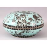 A LARGE CHINESE TURQUOISE GROUND CIRCULAR BOX AND COVER, the exterior decorated with flowers, the