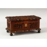 A CHINESE CANTON CARVED WOOD BOX, the lid carved with a panel containing a landscape setting and