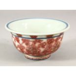 A CHINESE IRON RED AND BLUE PORCELAIN TEA BOWL, 9cm diameter.