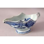 AN 18TH CENTURY CHINESE BLUE & WHITE PORCELAIN SAUCE BOAT - decorated with native floral decoration,