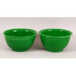 A PAIR OF CHINESE PEKING GREEN GLASS BOWLS, 11cm.