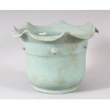 A CHINESE SONG STYLE CELADON PLANT POT, with circular script to base, 18cm diameter, 13cm high.