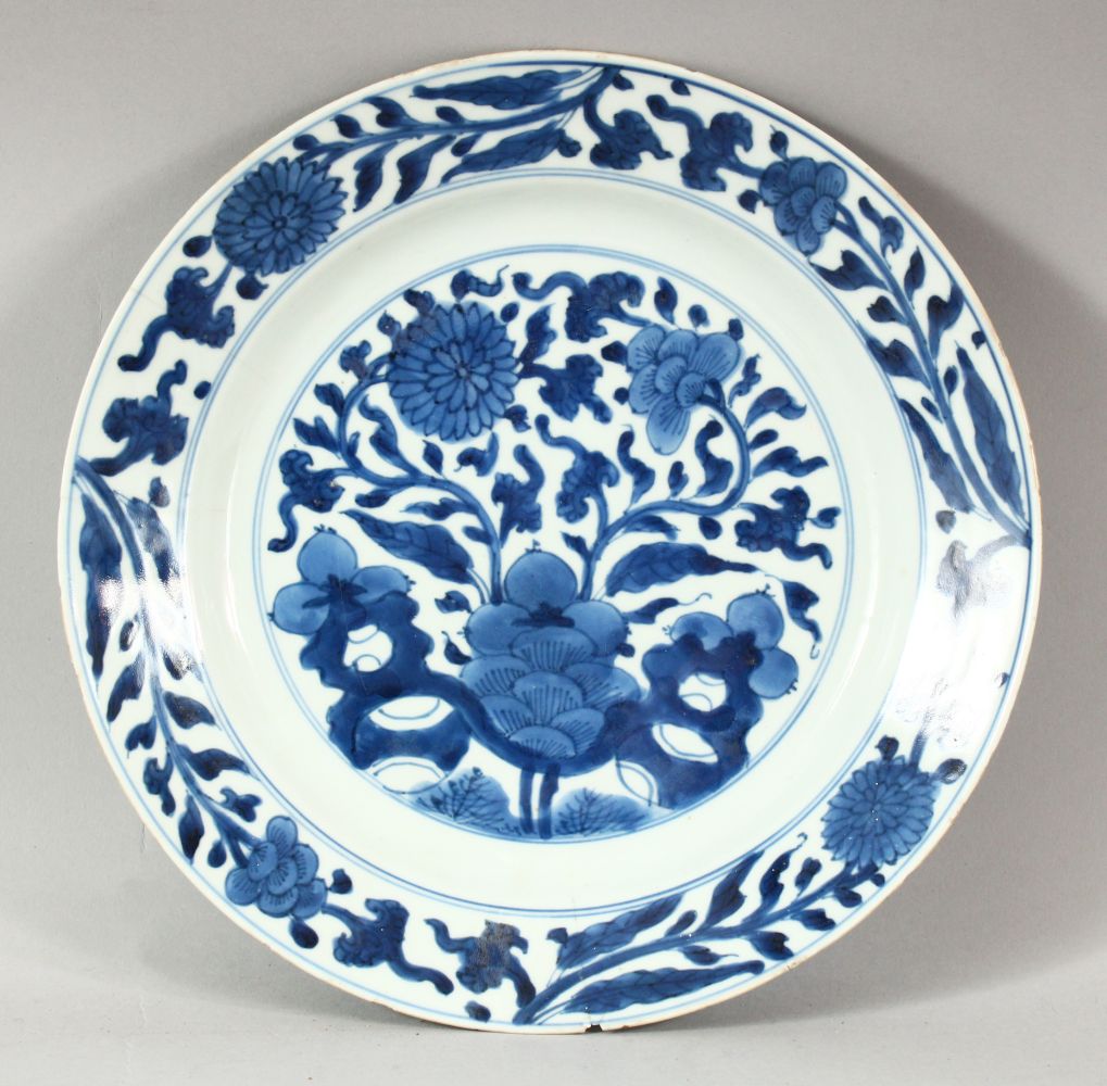 A CHINESE BLUE AND WHITE PORCELAIN DISH, decorated with flowers, 26.5cm diameter.