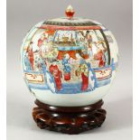 A GOOD CHINESE FAMILLE ROSE PORCELAIN JAR AND COVER on a hardwood stand, the jar painted with