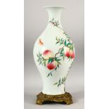 A CHINESE FAMILLE ROSE PORCELAIN PEACH VASE WITH GILT BRONZE STAND - the body of the vase