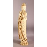 A SUPERB LARGE CHINESE IVORY TUSK CARVING OF A STANDING GUANYIN, the right hand raised, her left