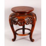 A JAPANESE CARVED HARDWOOD TRIPOD STAND - with a carved frieze of floral form, housing a vase or