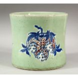 A LARGE CHINESE CELADON GLAZED BRUSH POT, the decorated with peaches, flora and forna, 17cm high,