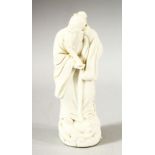 A SMALL CHINESE BLANC DE CHINE FIGURE OF A SAGE, 14.5cm high.