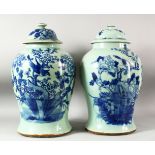 A LARGE PAIR OF CHINESE CELADON GLAZED POTTERY JARS AND COVERS, the jars painted with birds