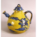 A CHINESE YELLOW GROUND GLAZED POTTERY TEAPOT AND COVER, the body with blue floral decoration,