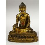 A GOOS SINO TIBETAN GILT BRONZE FIGURE OF BUDDHA / DEITY - in a seated pose holding flora, the