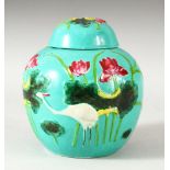A CHINESE TURQUOISE GLAZED MOULDED VASE AND COVER, the body with cranes and aquatic flora, overall