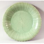 A CHINESE CELADON LOBED DISH, possibly 18th century, the centre incised with flowers, with early