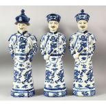 THREE LARGE CHINESE BLUE & WHITE PORCELAIN EMPEROR FIGURES, each stood with decorated robes with