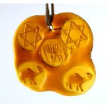 A JEWISH JUDAICA AMBER COLOUR GLASS HANGING / PENDANT - the glass impressed with related animals and