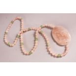 A CHINESE ROSE QUARTZ CARVED NECKLACE / PENDANT - with a carved pendant with beads, 74cm approx.