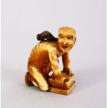 A JAPANESE MEIJI PERIOD CARVED IVORY SMALL OKIMONO OF A RAT CATCHER, the man leaning over his trap