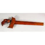 AN INDONESIAN KRIS WITH DAMASCUS BLADE, with carved wood hilt and plain wood scabbard, blade