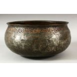 A LARGE 17TH CENTURY PERSIAN SAFAVID TINNED COPPER BOWL, the exterior rim with a band of