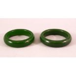 A PAIR OF CHINESE JADE BANGLES, both 8cm diameter.