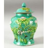 A CHINESE TURQUOISE GLAZED MOULDED JAR AND COVER, the body decorated with cranes amongst aquatic