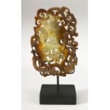 A CHINESE CARVED AND PIERCED HARDSTONE TABLET on stand, the tablet 14cm x 9cm, on stand 18.5cm