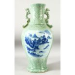 A LARGE CHINESE CELADON TWIN HANDLE VASE, decorated to each side with blue and white panels
