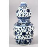 A CHINESE BLUE AND WHITE DOUBLE GOURD VASE, painted with lotus flowers, six character mark to rim,