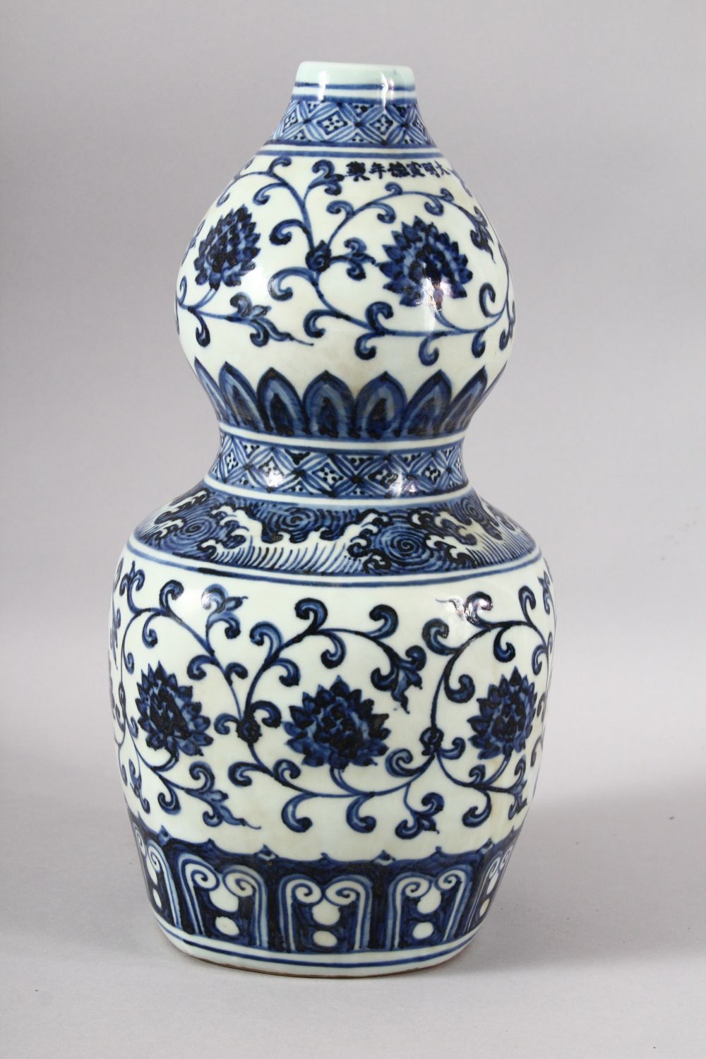 A CHINESE BLUE AND WHITE DOUBLE GOURD VASE, painted with lotus flowers, six character mark to rim, - Image 4 of 7