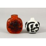 TWO CHINESE SNUFF BOTTLES - one with a white ground with black overlay, the other with carved relief