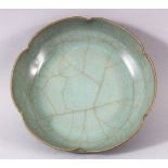 A CHINESE CRACKLE GLAZE CELADON BOWL, the base with circular calligraphic script, 16cm diameter.