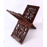 A LARGE CHINESE SIAMESE CARVED WOODEN BOOK STAND, carved with openwork of mythical beast and