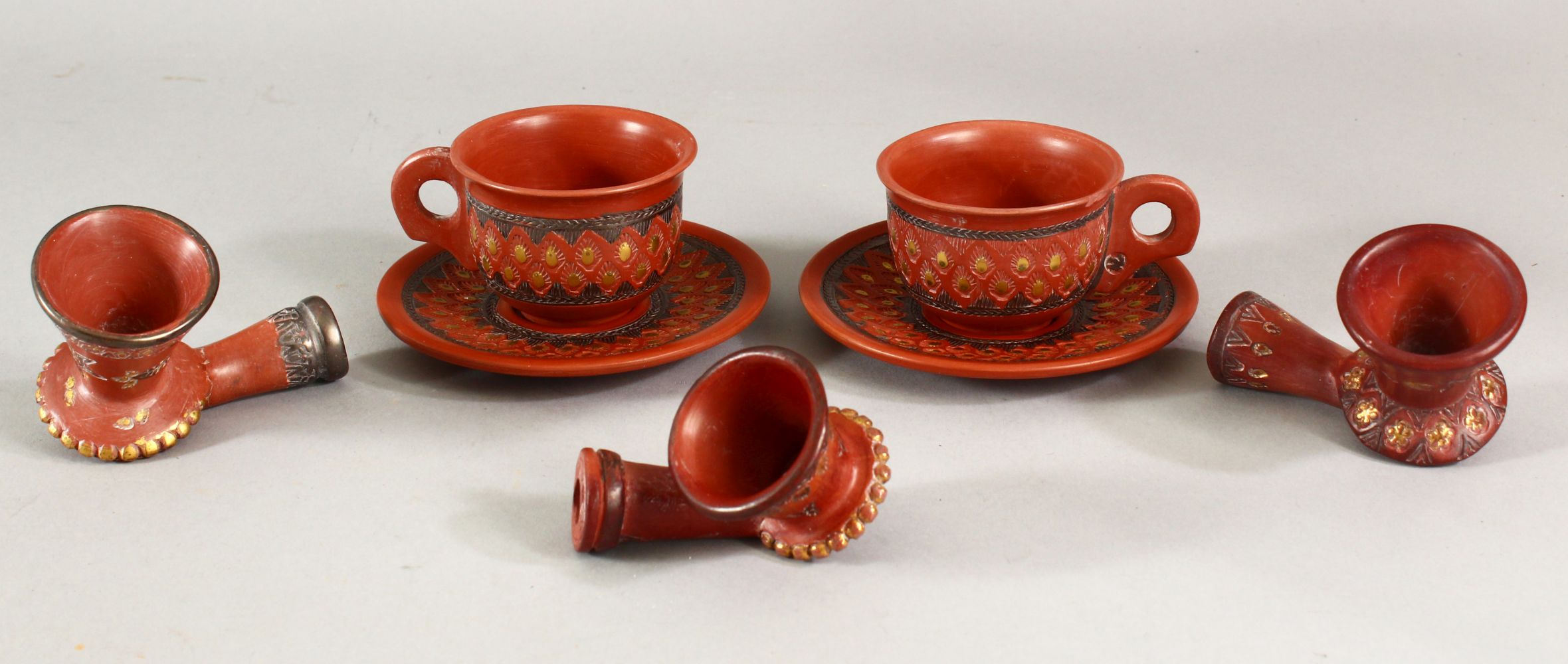 A MIXED LOT OF TURKISH TOPHANE POTTERY - comprising 2 x cup & saucers plus 3 x pipes.