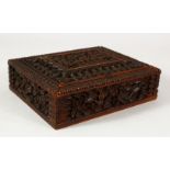 A SMALL EASTERN CARVED WOOD BOX, the interior with fitted compartments, 13.5cm x 11cm.