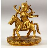 A CHINESE GILT BRONZE FIGURE OF A MAN RIDING AN ASS on a lotus form base, 22cm high.