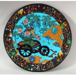 A CHINESE BLUE GROUND CLOISONNE DISH, depicting a cart with flowers, 31cm diameter.